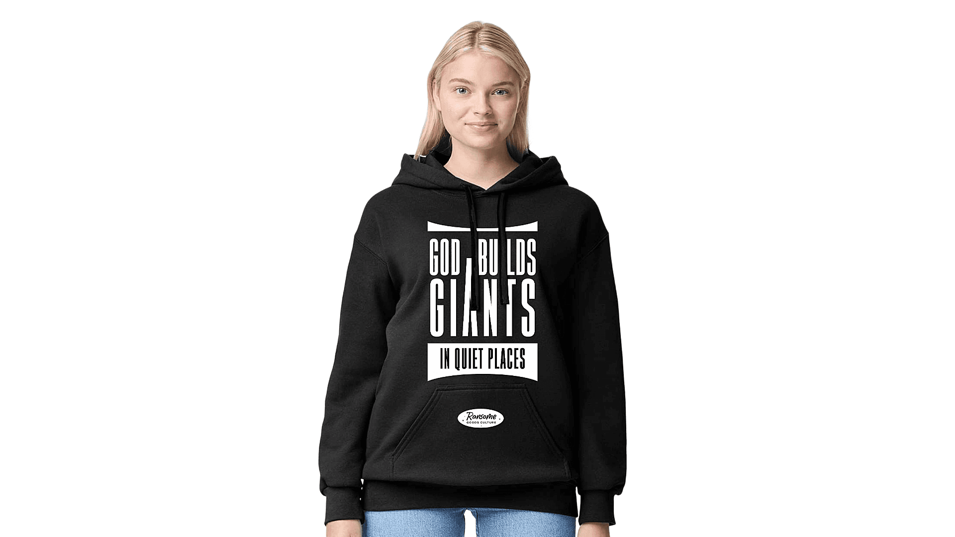 Blonde woman wearing a black hoodie with white text: GOD BUILDS GIANTS IN QUIET PLACES.