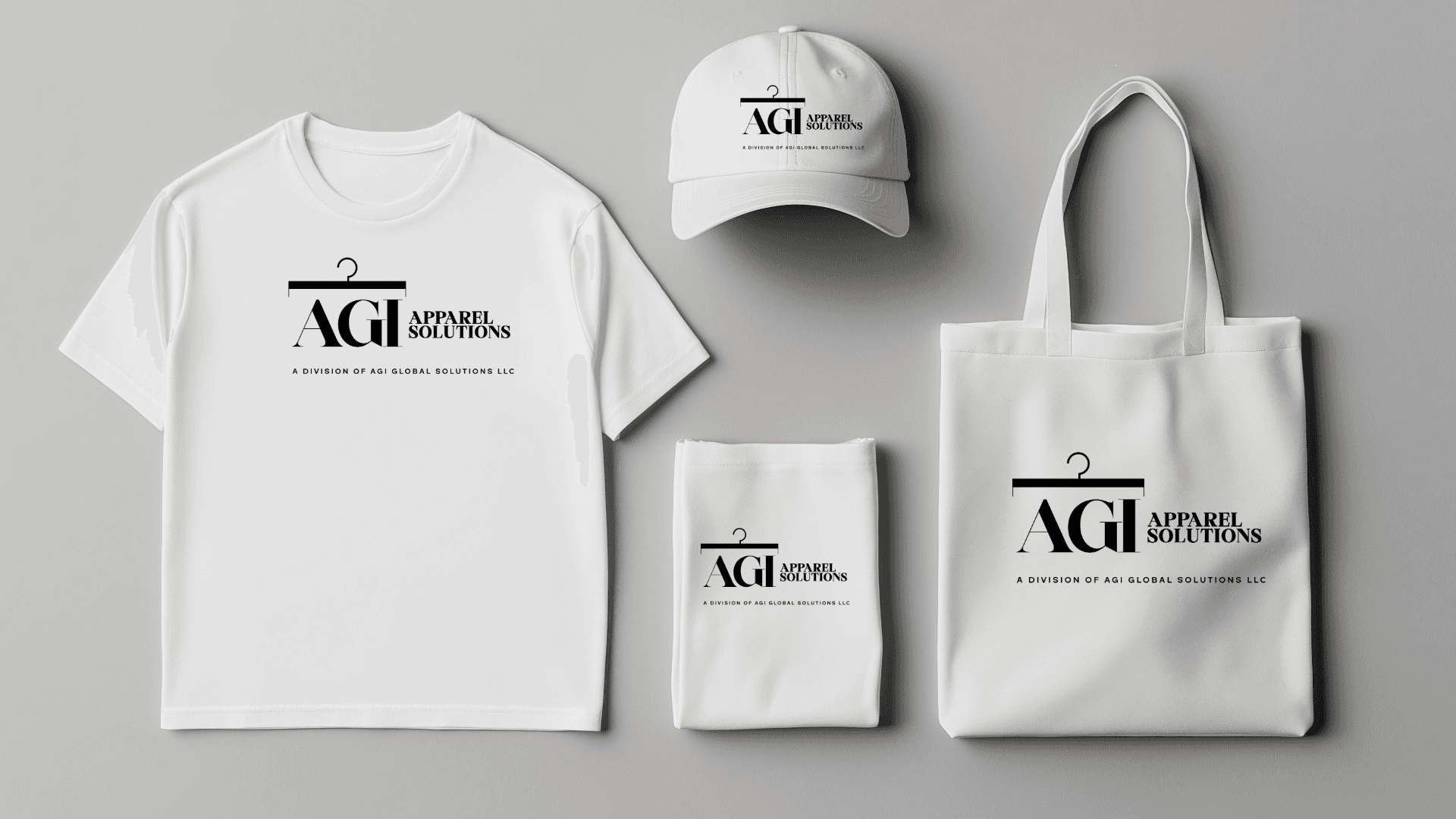 White t-shirt, baseball cap, and tote bag featuring the black AGI Apparel Solutions logo.